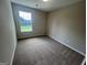 Neutral bedroom featuring a window view and comfortable brown carpet at 160 Odyssey Turn, Conyers, GA 30012
