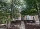 Charming two-story home with a pathway and mature trees in the front yard at 160 Odyssey Turn, Conyers, GA 30012