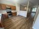 Bright kitchen with wooden cabinetry and stainless steel appliances; laminate flooring at 160 Odyssey Turn, Conyers, GA 30012