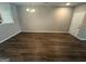 Open living room featuring laminate flooring, a chandelier, and access to other rooms at 160 Odyssey Turn, Conyers, GA 30012