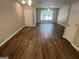 Open living room featuring laminate flooring and a large window at 160 Odyssey Turn, Conyers, GA 30012