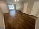 Bright living room with wood floors, ceiling fan, and a large window that provides lots of natural light at 160 Odyssey Turn, Conyers, GA 30012