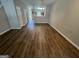 Bright living room featuring laminate flooring and access to other rooms at 160 Odyssey Turn, Conyers, GA 30012