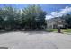 A street view of attached brick and vinyl homes with mature landscaping at 160 Odyssey Turn, Conyers, GA 30012
