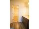 Bathroom featuring dark wood cabinets, neutral countertop, and a walk-in closet at 6342 Kinsland Ct, Lithonia, GA 30058