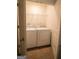 Convenient laundry room equipped with a washer, dryer, and shelving for storage at 6342 Kinsland Ct, Lithonia, GA 30058