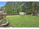 Backyard with lush grassy area, shed, and a play set at 9138 Sunset Dr, Jonesboro, GA 30238