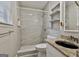 Modern bathroom featuring a tiled shower, granite vanity, and convenient built-in shelves at 9138 Sunset Dr, Jonesboro, GA 30238