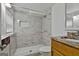 Bathroom with tile shower, granite countertop vanity, and stylish mirror at 9138 Sunset Dr, Jonesboro, GA 30238