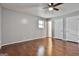 Neutral bedroom showcases hardwood floors, ceiling fan, and ample natural light at 9138 Sunset Dr, Jonesboro, GA 30238