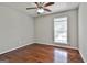 Bedroom features ceiling fan, window with blinds, and warm, hardwood floors at 9138 Sunset Dr, Jonesboro, GA 30238