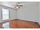 Bright bedroom features ceiling fan and gleaming hardwood floors, offering a comfortable retreat at 9138 Sunset Dr, Jonesboro, GA 30238