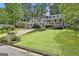 Two-story home with well-maintained lawn and mature trees in a peaceful neighborhood at 9138 Sunset Dr, Jonesboro, GA 30238