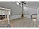 Open living room with high ceilings, wood floors, and view into adjacent dining area at 9138 Sunset Dr, Jonesboro, GA 30238