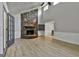 Bright living room with vaulted ceiling, stone fireplace, and adjacent dining area at 9138 Sunset Dr, Jonesboro, GA 30238