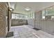 Enclosed sunroom features tile floors, multiple windows, and access to the outdoors at 9138 Sunset Dr, Jonesboro, GA 30238