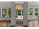 Looking through the doors to the back porch with brick pillars and a pool in the back yard at 150 Dean Dr, Tyrone, GA 30290