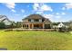 This home offers an expansive backyard with lush lawn and outdoor entertaining areas at 150 Dean Dr, Tyrone, GA 30290