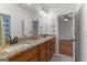 Spacious bathroom with double vanity, granite counters, and well-lit mirrors with a view to bedroom at 150 Dean Dr, Tyrone, GA 30290