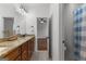 Bathroom featuring double granite vanity and tile floor with shower and adjacent bedroom at 150 Dean Dr, Tyrone, GA 30290