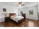 Bedroom with hardwood floors, ceiling fan, two windows, and a traditional furniture set at 150 Dean Dr, Tyrone, GA 30290