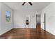 Bedroom with hardwood flooring, ceiling fan, window, and doors to adjacent rooms at 150 Dean Dr, Tyrone, GA 30290
