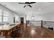 Bright bonus room features wood floors, tall ceilings, ceiling fan, and decorative stair railing at 150 Dean Dr, Tyrone, GA 30290