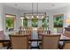 Dining room featuring a wooden table with seating and bright windows overlooking the yard at 150 Dean Dr, Tyrone, GA 30290