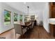 Bright dining room boasts hardwood floors, large windows, and a stylish light fixture at 150 Dean Dr, Tyrone, GA 30290