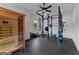 Well-equipped exercise room with sauna, weights, punching bag, and ceiling fan at 150 Dean Dr, Tyrone, GA 30290