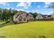 A luxurious home situated on a large lot, featuring a lush lawn and well-maintained landscaping at 150 Dean Dr, Tyrone, GA 30290