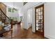Spacious foyer featuring hardwood floors, staircase, half bath, and views into the living room at 150 Dean Dr, Tyrone, GA 30290