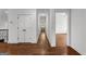 Hallway with hardwood flooring, storage closet, and access to adjacent bedroom and other rooms at 150 Dean Dr, Tyrone, GA 30290
