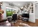 Well-lit home office featuring wood floors, desk and decorative wall art at 150 Dean Dr, Tyrone, GA 30290