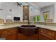 Spacious kitchen featuring a copper sink, granite countertop, open floor plan and natural light at 150 Dean Dr, Tyrone, GA 30290