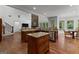 Spacious kitchen with an island, stone fireplace, bar seating and hardwood flooring at 150 Dean Dr, Tyrone, GA 30290