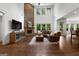 Open living room with stone fireplace, hardwood floors and large windows for natural light at 150 Dean Dr, Tyrone, GA 30290