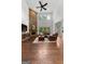 Open living room with stone fireplace, hardwood floors and large windows at 150 Dean Dr, Tyrone, GA 30290