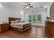 Spacious main bedroom featuring tray ceilings, a ceiling fan, and large windows for ample natural light at 150 Dean Dr, Tyrone, GA 30290