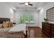 Bright main bedroom showcasing tray ceilings, a ceiling fan, and large windows for a peaceful ambiance at 150 Dean Dr, Tyrone, GA 30290