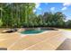 A luxury pool with a rock border and a waterfall feature for backyard relaxation at 150 Dean Dr, Tyrone, GA 30290