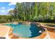 Gorgeous pool with stone accents and a built in spa offers a tranquil retreat at 150 Dean Dr, Tyrone, GA 30290