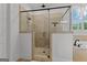 Modern tiled shower with glass enclosure features dual shower heads and attractive mosaic tile accents at 150 Dean Dr, Tyrone, GA 30290