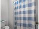 A full shot of the shower featuring white tile and a blue and white shower curtain at 150 Dean Dr, Tyrone, GA 30290