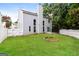 Backyard featuring a well-maintained lawn, a patio, a fire pit, and a white picket fence at 2801 Priestcliff Dr, Smyrna, GA 30080