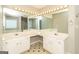 Bright bathroom featuring a double vanity, jacuzzi tub, large mirror with vanity lighting, and black & white tile floor at 2801 Priestcliff Dr, Smyrna, GA 30080