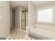 Bathroom featuring a tub with a gold shower, a separate shower stall, and black and white tile flooring at 2801 Priestcliff Dr, Smyrna, GA 30080