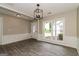 Dining area with decorative lighting fixture, modern flooring, and large window with a view at 2801 Priestcliff Dr, Smyrna, GA 30080