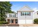 Two-story home with a two-car garage, black shutters, and a well-maintained front yard at 2801 Priestcliff Dr, Smyrna, GA 30080