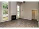 Bright living room with a fireplace, tall windows, and stylish wood-look tile flooring at 2801 Priestcliff Dr, Smyrna, GA 30080